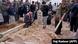 Mourners attend the funeral of Raed Fares and Hammoud al-Juneid in the village of Kafr Nabel in the northwestern province of Idlib on November 23.