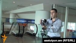 Armenia - An official at Yerevan's Zvartnots airport shows a device used for screening arriving passengers for possible symptoms of Ebola, 21Oct2014.