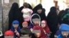 Tajik women and their children await their fate in an Iraqi court in January.