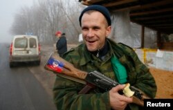 A pro-Russian rebel guards a checkpoint outside of the town of Horlivka northeast of Donetsk, on December 14.