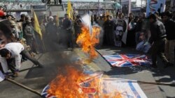 Iran -- Iranians burn an Israeli flag during a rally marking the anniversary of the 1979 Islamic revolution, Tehran, February 11, 2018