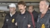 Convicted Russian arms dealer Viktor Bout (center) is escorted by U.S. Drug Enforcement Administration officers after arriving in the United States following his extradition from Thailand last year. 