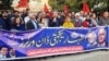 FILE: Journalists and civil society leaders protest the harassment of journalists working for Dawn, a leading English language daily in December.