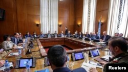 Syria's main opposition High Negotiations Committee (HNC) leader Naser al-Hariri and UN Special Envoy for Syria Staffan de Mistura attend a round of negotiation, during the Intra Syria talks, in Geneva, May 16, 2017