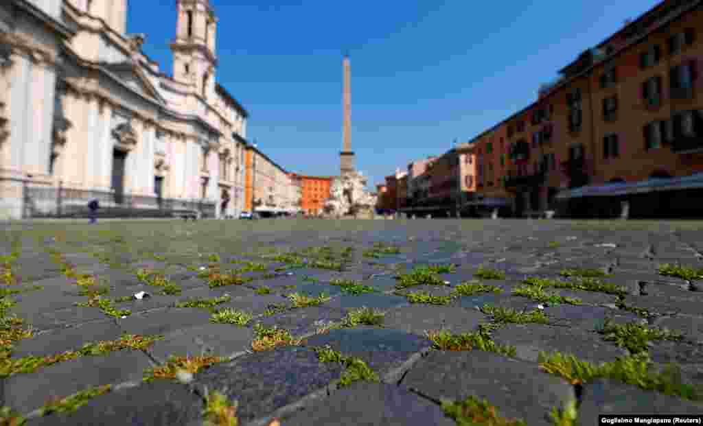 Grass sprouts between the cobbles of Rome&rsquo;s famous Piazza Navona on April 9, weeks into a lockdown that has virtually ended tourist foot traffic.