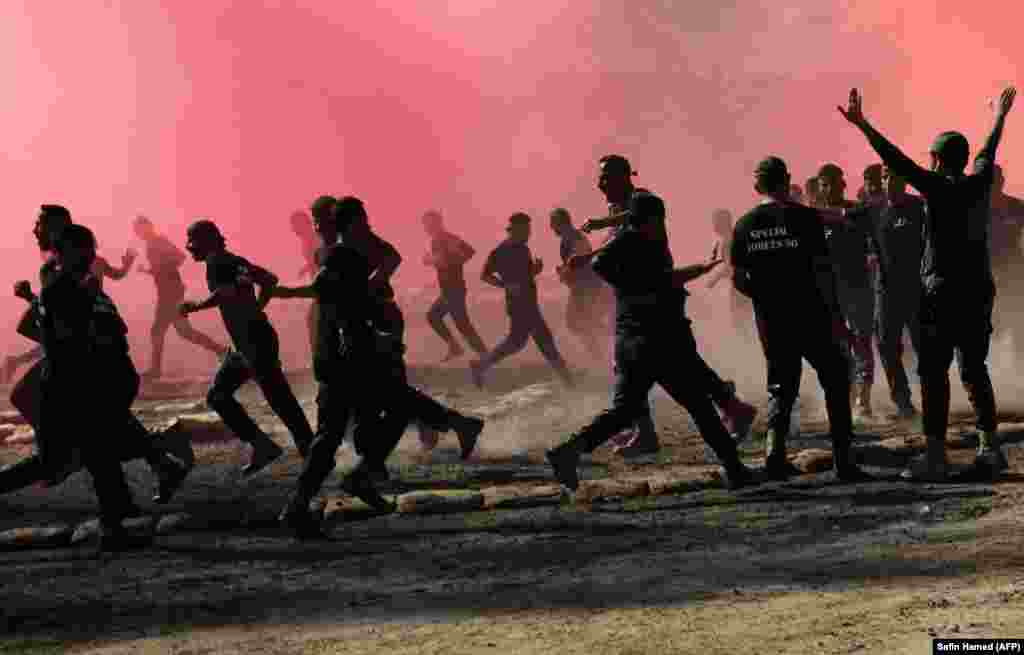 Iraqi Kurdish Peshmerga officers perform drills as they take part in a graduation ceremony in the Kurdish town of Soran, about 100 kilometers northeast of Irbil, the capital of Iraq&#39;s autonomous Kurdish region. (AFP/Safin Hamed)