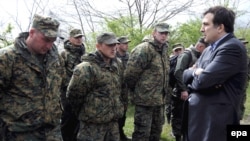 Georgian President Mikheil Saakashvili (right) talks with soldiers who took part in a mutiny at the Mukhrovani military base on May 5.