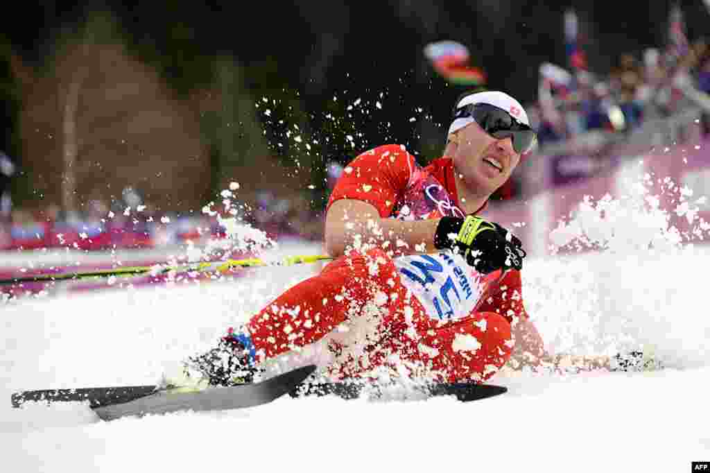 Switzerland&#39;s gold medalist Dario Cologna (35) crosses the finish line in the men&#39;s 15-kilometer cross-country skiing classic. It was Cologna&#39;s second cross-country skiing gold, after a victory in the skiathlon on February 9. (AFP/Kirill Kudryavtsev)