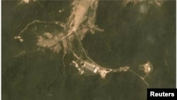 A combination of two satellite images taken on June 22, 2018 (top) and July 22, 2018 show activity at the Sohae rocket launch site in North Korea. Planet Labs Inc/Handout via REUTERS 