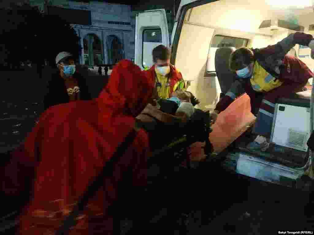An injured person is attended to in an ambulance. More than 120 people were treated in Bishkek hospitals. 