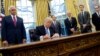 U.S. President Donald Trump signs an executive order on January 23.