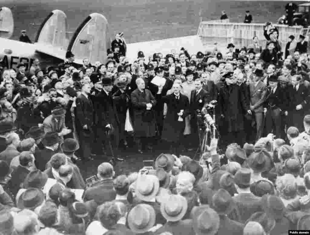 In London on September 30, 1938, Neville Chamberlain holds up the paper containing the resolution to commit to peaceful methods signed by both Hitler and himself on his return from Munich. "My good friends, for the second time in our history a British prime minister has returned from Germany bringing peace with honour. I believe it is peace for our time," he said.