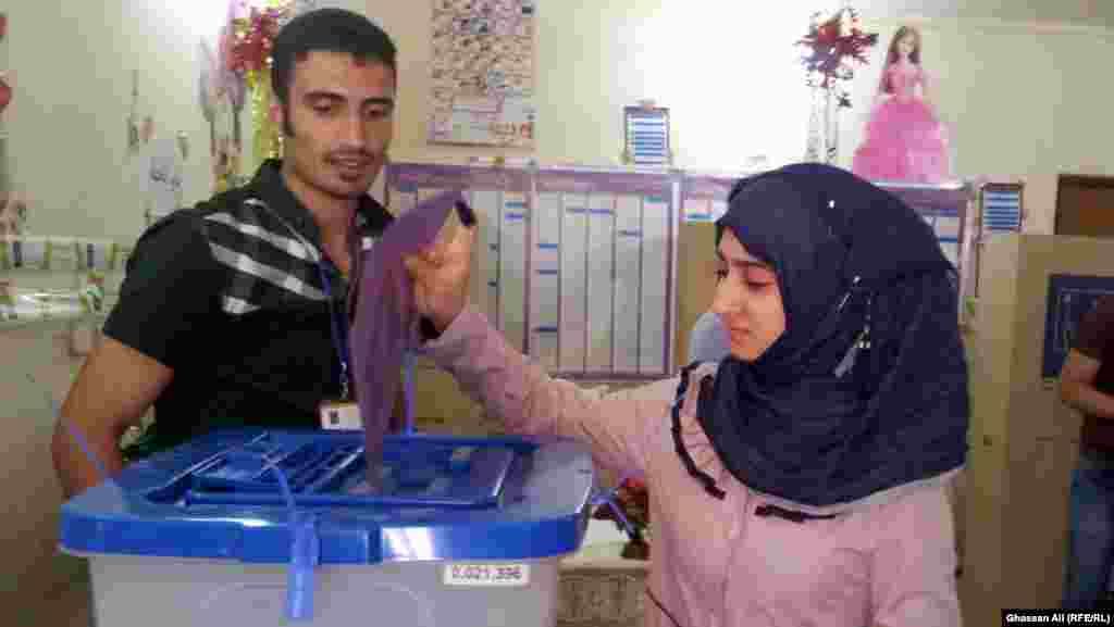 A young woman from Baghdad casts her ballot.