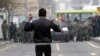 An opposition protester holds stones as he faces security forces. (AFP)