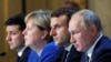 Ukrainian President Volodymyr Zelenskiy, (left to right) German Chancellor Angela Merkel, French President Emmanuel Macron, and Russian President Vladimir Putin attend a press conference after a summit on Ukraine at the Elysee Palace in Paris in December 2019.