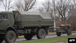 A truck tows a 122-millimeter artillery piece on a main road east of Donetsk on November 11.