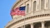 U.S. – Capitol Building dome detail with US flag waving.