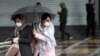 Iranian women wear protective masks to prevent contracting coronavirus, as they walk in the street in Tehran, Iran February 25, 2020.