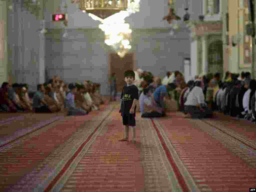 A Muslim boy attends the weekly Friday Prayer at the Omayyad Mosque in central Damascus, Syria, on August 26. Photo by Joseph Eid for AFP