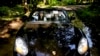 In this picture taken on Friday, May 24, 2013, two Iranian women ride in a Porsche, in Noor forest, northern Iran. (AP Photo/Ebrahim Noroozi)