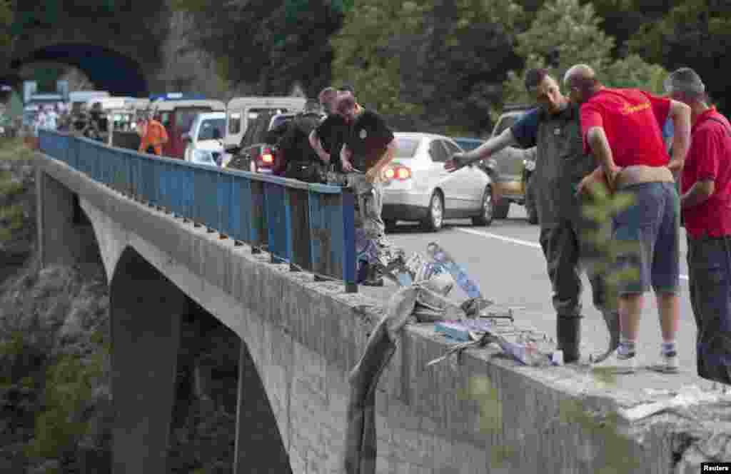 Thirteen people died and 32 others were injured when a Romanian bus carrying some 46 passengers crashed through a guardrail and plunged into a gorge in Montenegro. (Reuters/Stevo Vasiljevic)