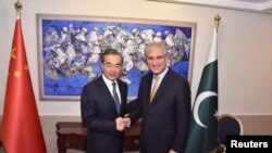 Pakistan's Foreign Minister Shah Mehmood Qureshi shakes hand with State Councillor and Foreign Minister Wang Yi at the Ministry of Foreign Affairs in Islamabad on September 8.