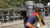 A police officer fires rubber bullets during a protest against the government of Venezuelan President Nicolas Maduro in Caracas on January 23.&nbsp;Maduro was sworn in early in January following his reelection in a poll considered fraudulent by much of the international community.