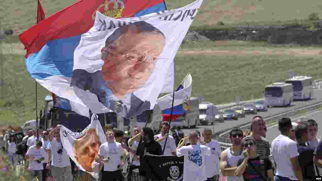 Ethnic Serbs carry national flags and pictures of ultranationalist leader Vojislav Seselj as they gather in Gazimestan.