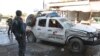 Security personnel inspect the site of a suicide attack on the outskirts of the eastern city of Jalalabad on June 13.