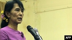 Aung San Suu Kyi speaks at a meeting inside the National League For Democracy party headquarters in Yangon on November 18.