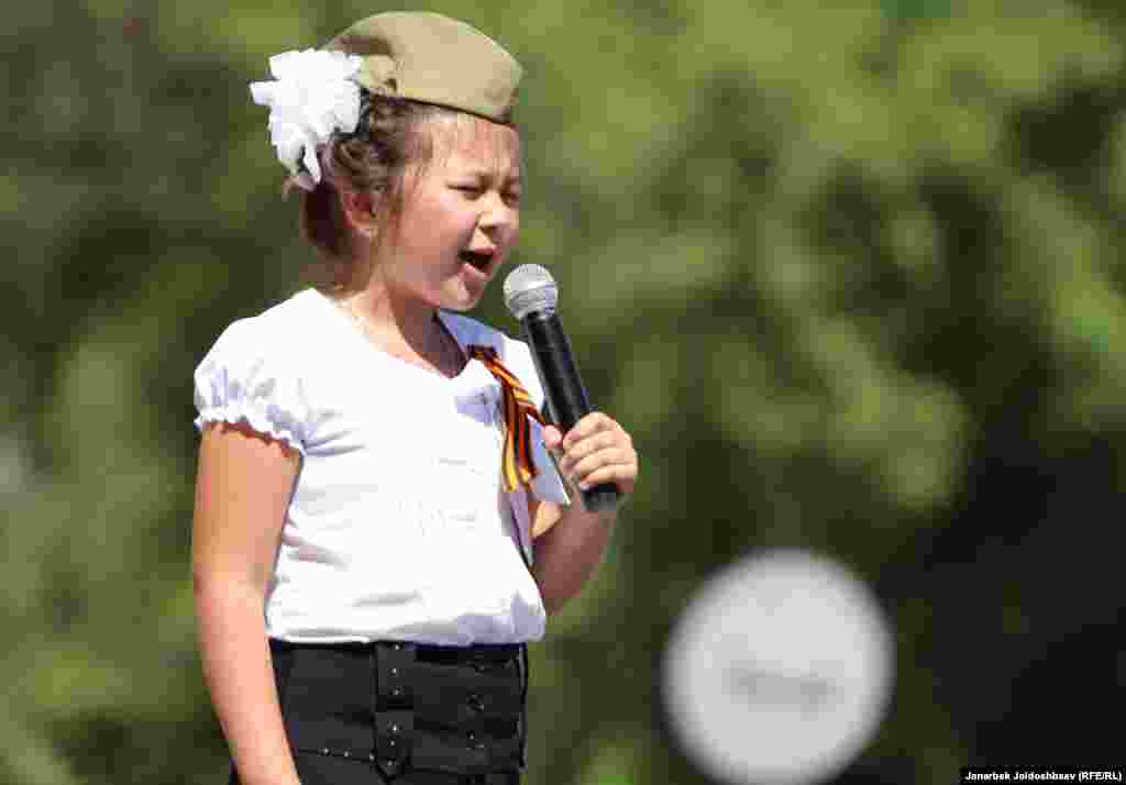 A girl sings at a Victory Day event in Bishkek, Kyrgyzstan.