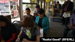 People using wireless internet in public bus.