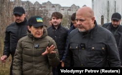 Prosecutor-General Iryna Venediktova (left) and International Criminal Court Prosecutor Karim Khan visit the site of a mass grave in the town of Bucha on April 13.