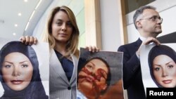 Belgium -- Member of the EU Parliament Barbara Matera (L) displays pictures of Iranian woman Neda Agha-Soltan, killed last year during a post election anti-government protest in Tehran, as she waits for the arrival of Iranian Foreign Minister, Brussles, 0