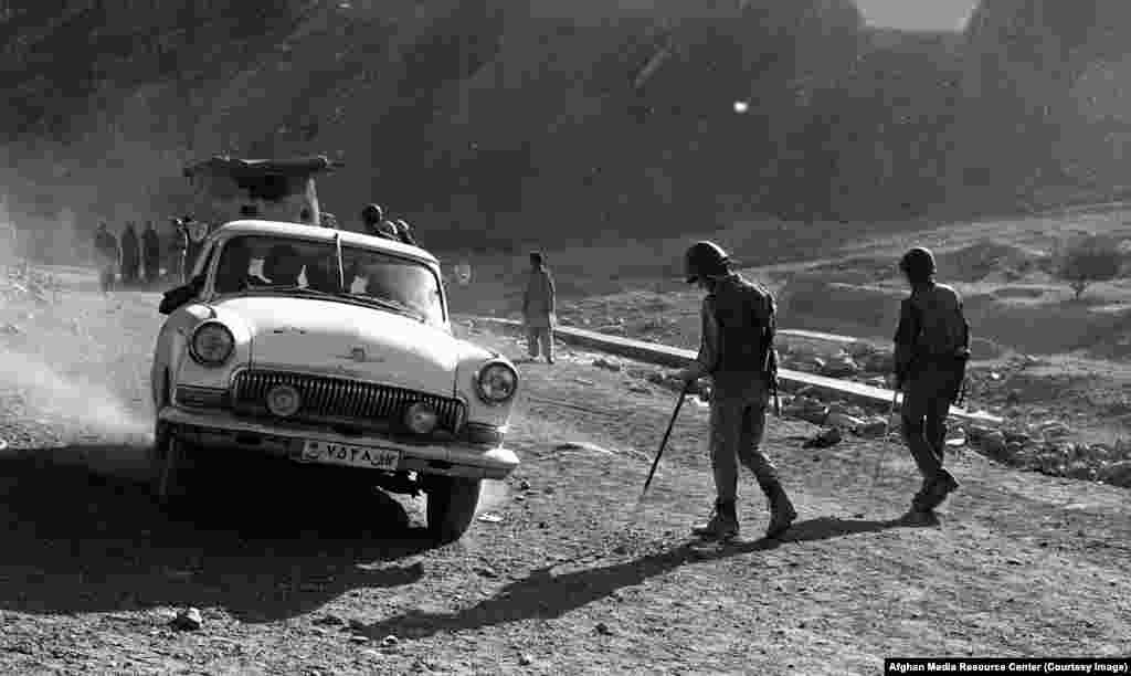 Soviet soldiers prod for land mines on a road in Afghanistan's Panjshir Province. One troop recalled, "There was no such thing as a peaceful population, they were all guerrilla fighters."