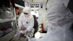 Бразильские медики в защитных костюмах. 18 мая 2020 года.