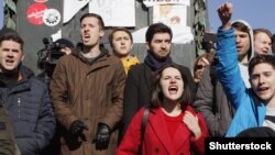Young protesters shout slogans at Pushkin Square during a mass rally against corruption in the government of Russian President Vladimir Putin in Moscow on March 26.