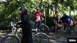 Women must be fully covered if they want to ride a bike in public. But officially riding bikes is banned for them. FILE PHOTO