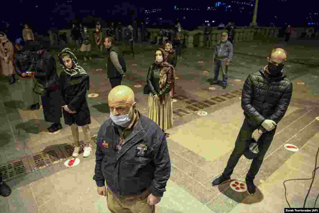 Worshipers practice physical distancing during a mass at Trinity Cathedral in the Georgian capital, Tbilisi, on April 18. Only a few priests accompanied by volunteers conducted the service after most people stayed away from Easter celebrations in an effort to limit the spread of COVID-19.