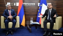 Poland -- French President Francois Hollande (R) and Armenian Prime Minister Serzh Sargsyan have taken seat for bilateral talks on the sidelines of a NATO summit in Warsaw, Poland, on July 9, 2016.