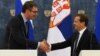 Serbian Prime Minister Aleksandar Vucic (left) and Russian Prime Minister Dmitry Medvedev shake hands at a press conference in Moscow on July 7.