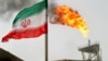 FILE PHOTO: A gas flare on an oil production platform in the Soroush oil fields is seen alongside an Iranian flag