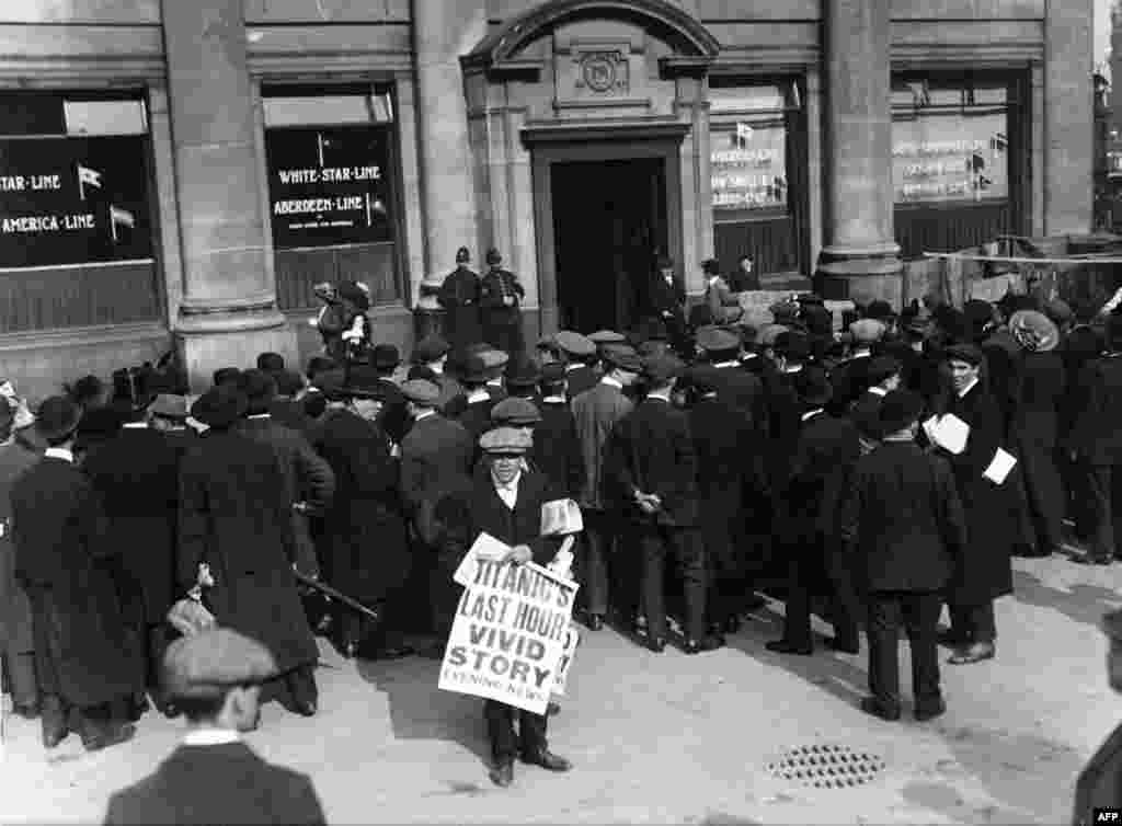 A newsboy hawks a special edition outside the offices of the White Star Line in London after news of the sinking of the &quot;Titanic&quot; hit the streets.