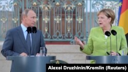 Володимир Путін та Ангела Меркель