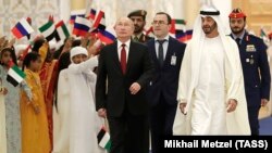 Russian President Vladimir Putin (left) and Sheikh Muhammad bin Zayed al-Nahyan, crown prince of Abu Dhabi, review a guard of honor during a welcome ceremony at the presidential palace on October 15.