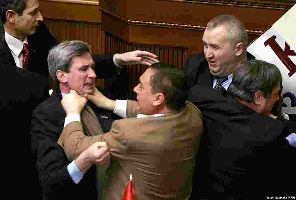 Deputies of Ukraine&#39;s parliament going at it before the annual speech by then Ukrainian President Viktor Yushchenko in February 2006. The fighting erupted after Communist Party members attempted to attach a placard to the speaker&#39;s platform.