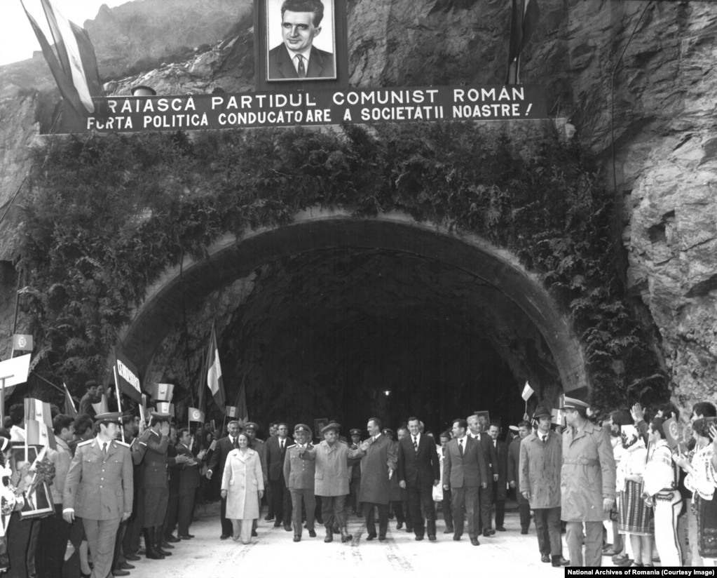 Nicolae and Elena Ceausescu attend the official opening of the Transfagarasan on September 20, 1974. The propaganda banner declares: "Long live the Communist Party, the leading political force in our society."