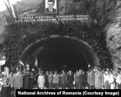 Nicolae and Elena Ceausescu attend the official opening of the Transfagarasan on September 20, 1974. The propaganda banner declares: "Long live the Communist Party, the leading political force in our society."