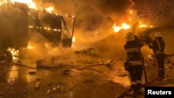 Firefighters work to put out a blaze at a site where warehouse facilities were hit by a Russian drone strike in the village of Murovane, outside of Lviv, Ukraine, on September 6.