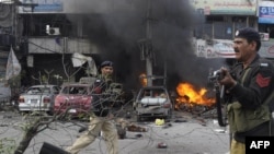 Pakistani policemen arrive at the site of a bomb explosion in Lahore on February 17.